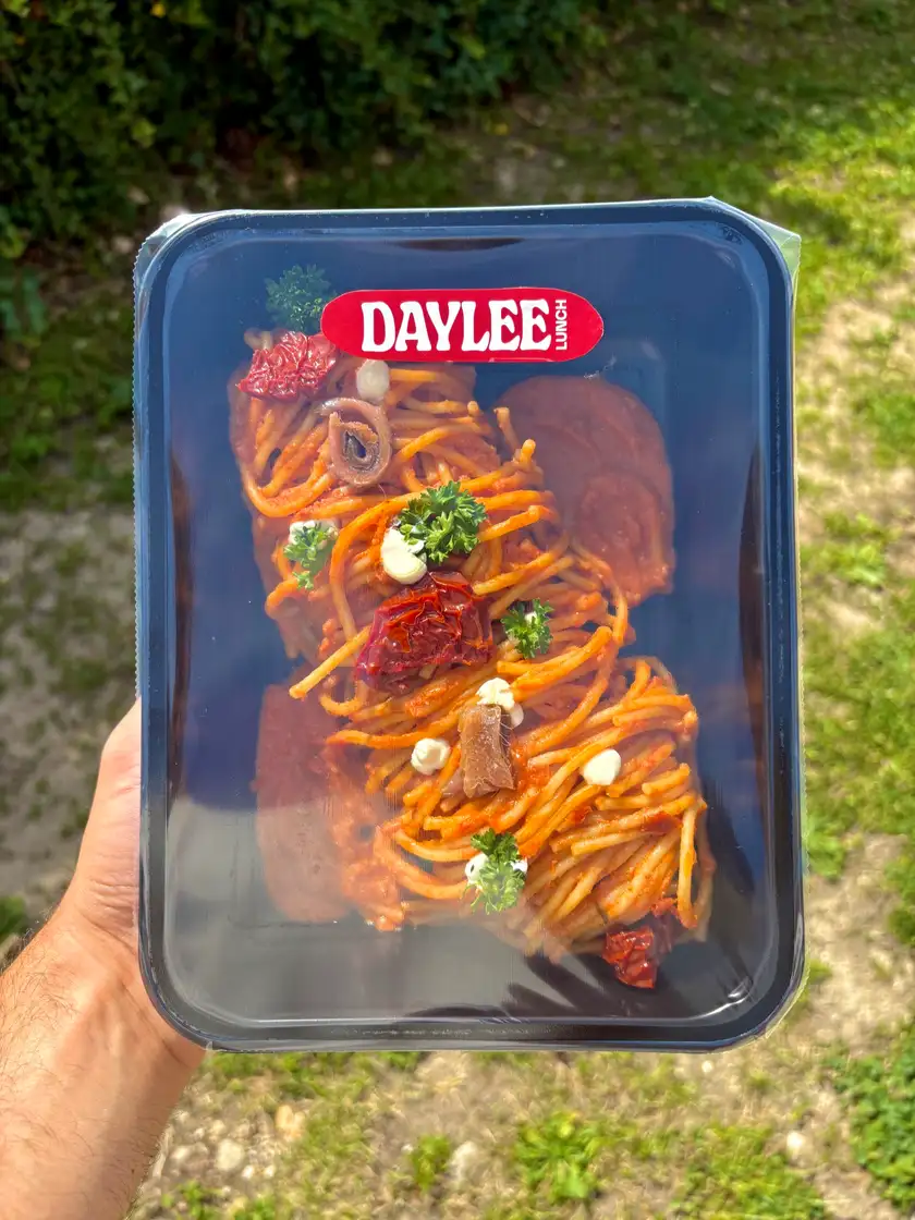 Barquette Daylee tenue en main : spaghetti à la sauce tomate